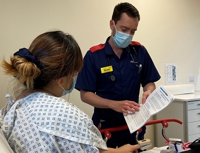 Consultant Nurse Sean Harding explains the virtual ward process to a patient