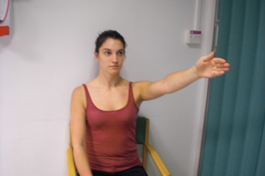 Patient seated with arm outstretched in front and palm facing inwards.